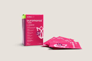 Pink Ouromanoz Rapid D-Mannose box with scattered pink sachets featuring the brand logo on a beige background