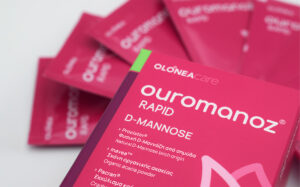 Close-up of pink packaging for 'ourmanoZ RAPID D-MANNOSE' with a list of ingredients on the front.