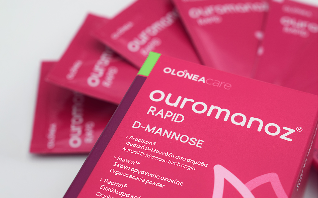 Close-up of pink packaging for 'ourmanoZ RAPID D-MANNOSE' with a list of ingredients on the front.