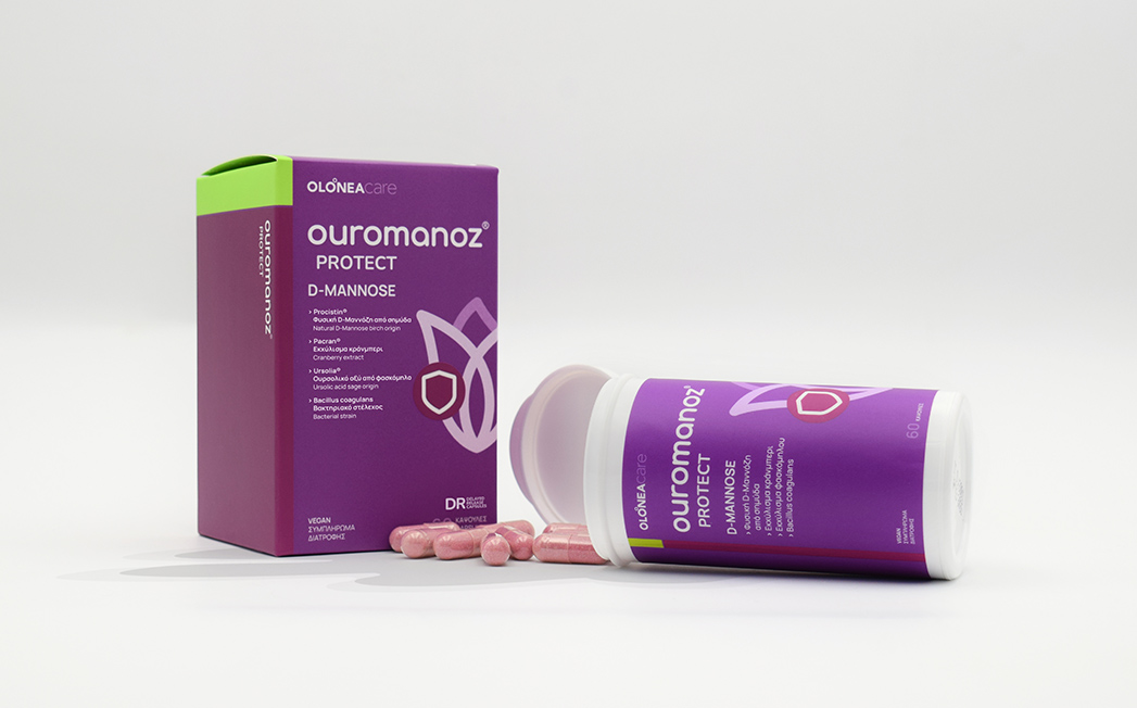 Ouromanoz Protect D-Mannose supplement box and bottle with pink pills spilled in front on a white background.