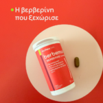 Red Berberine supplement bottle on a white plate with a single brown capsule beside it on a red background.