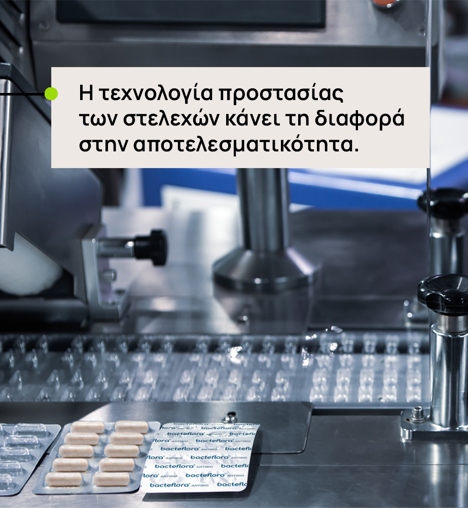 Pharmaceutical production bench with blister packs; Greek caption states staff protection technology makes a difference in effectiveness.